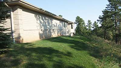Image of the side of a house with trees cleared away